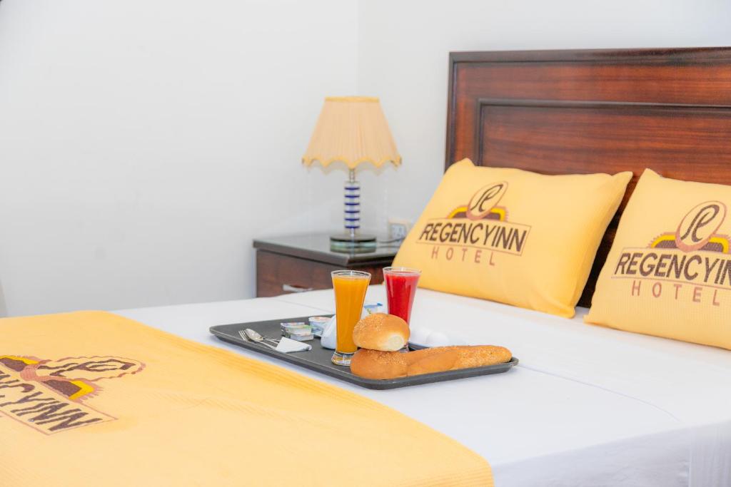 A bed or beds in a room at Regency inn