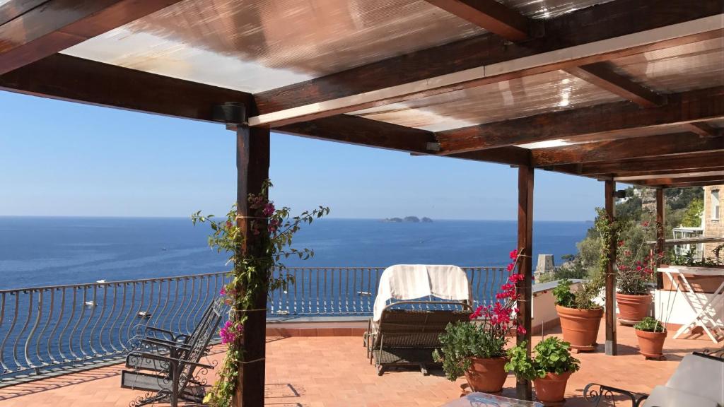 
a balcony overlooking a beach with a view of the ocean at Suite Antimo Original in Positano
