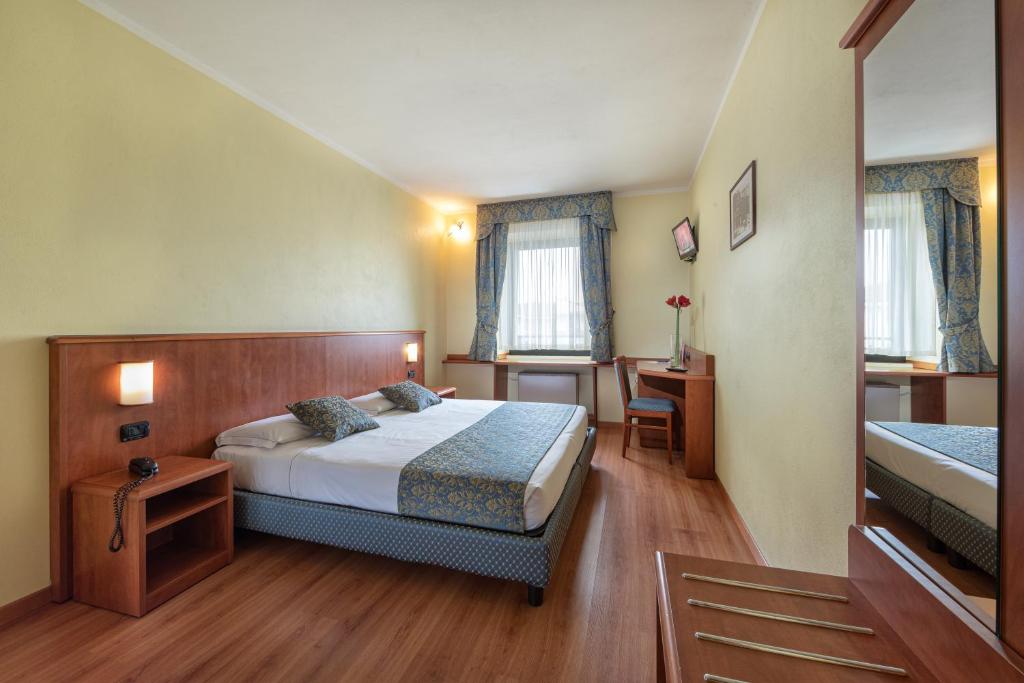 Postel nebo postele na pokoji v ubytování Hotel Postumia