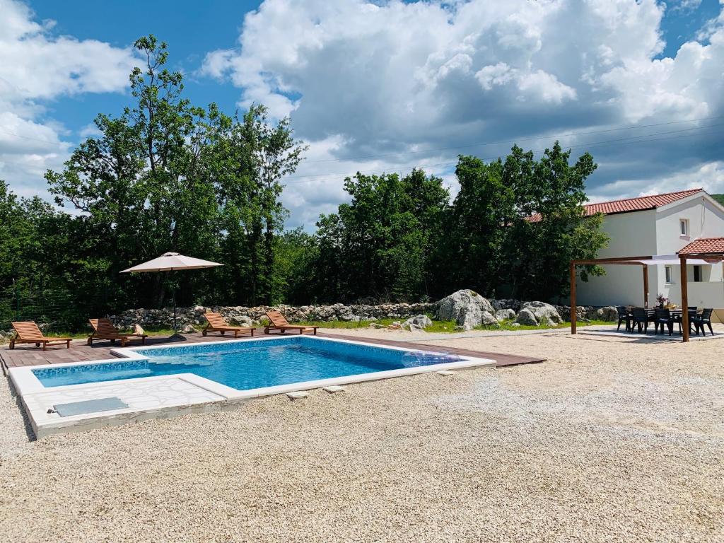 a swimming pool in a yard with a house at Bonaventura - Countryside Villa near Split with Private Pool in Donja Mala