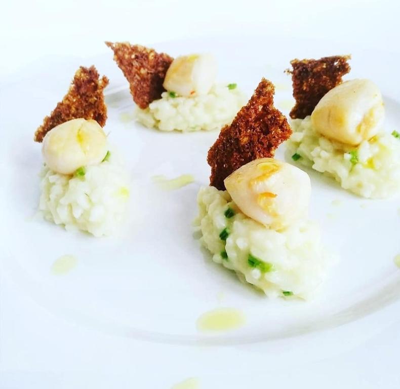a plate of rice with some food on it at Villa Sant'Angelo in Alba Adriatica