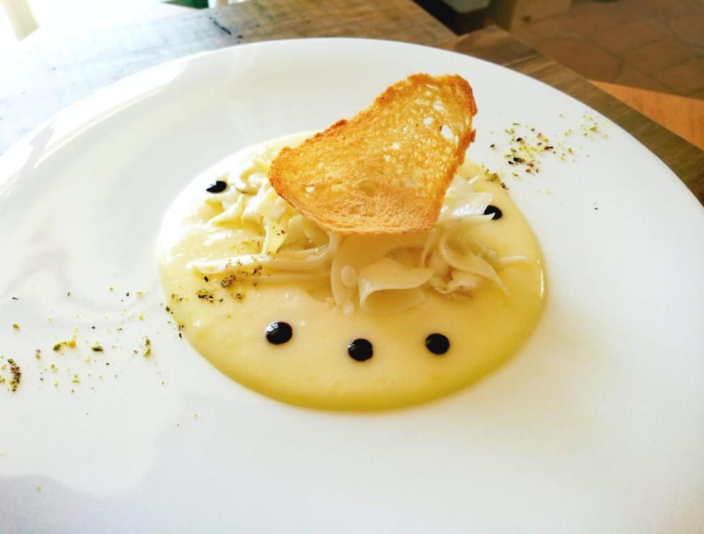 a plate of food with a piece of bread on top of pasta at Villa Sant'Angelo in Alba Adriatica