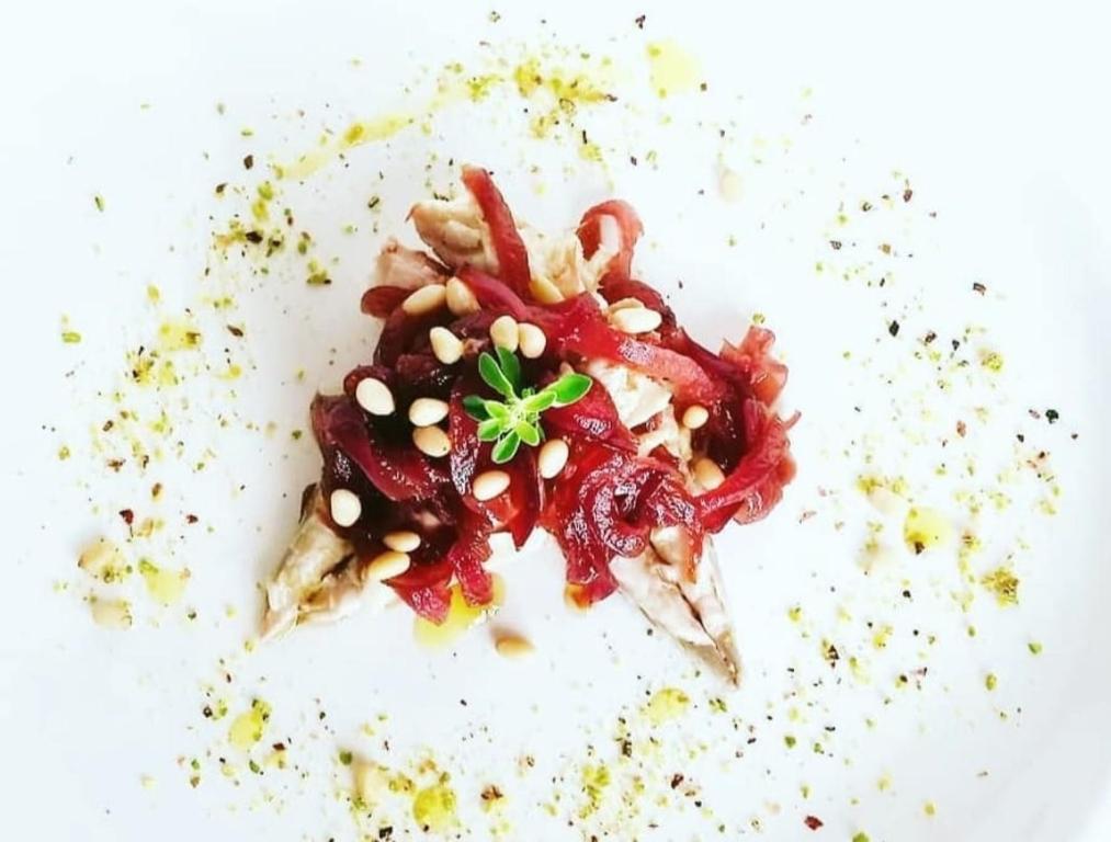 a white plate topped with food on a white table at Villa Sant'Angelo in Alba Adriatica