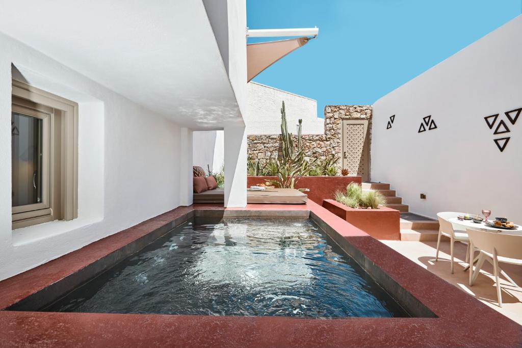 a swimming pool in the middle of a house at Domus Hestia Suites in Pyrgos