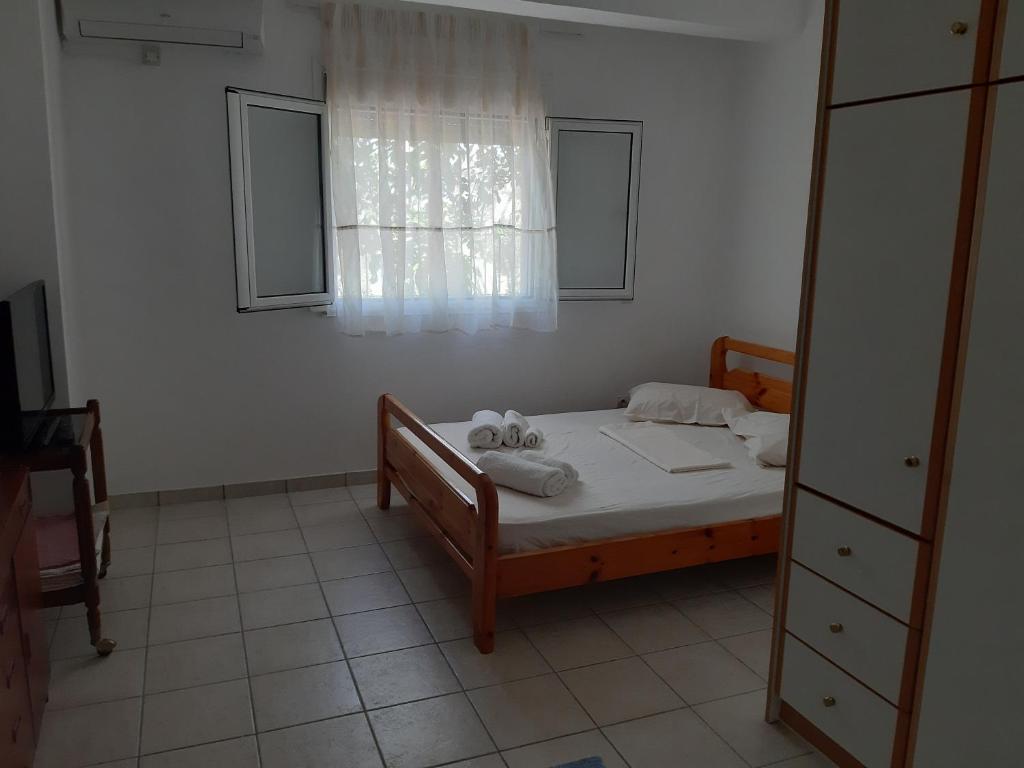 a bedroom with a bed and a window at Konstantina's House II in Koroni