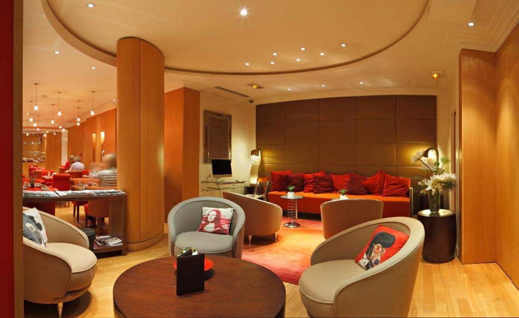 a hotel lobby with couches and chairs at Westside Arc de Triomphe Hotel in Paris