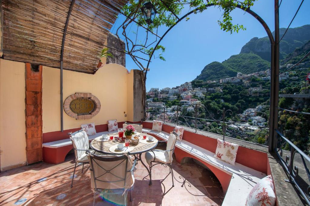 a table and chairs on a balcony with a view at Casa Giulia - sophisticated apartment with view in Positano