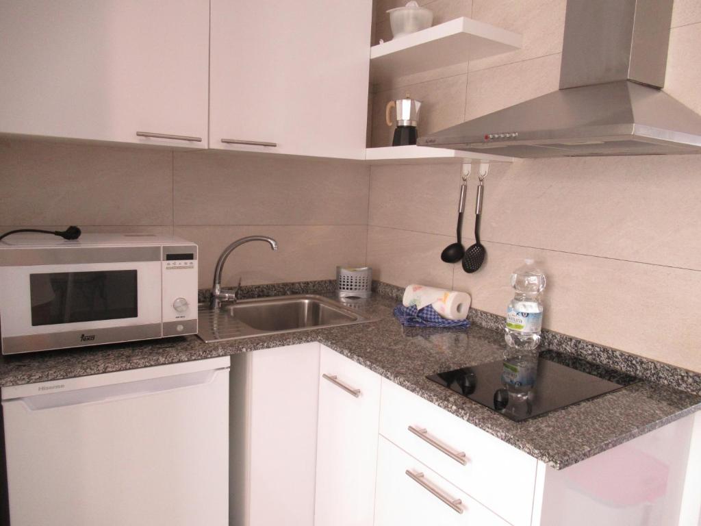A kitchen or kitchenette at La Rosita Sun Apartments, by Comfortable Luxury