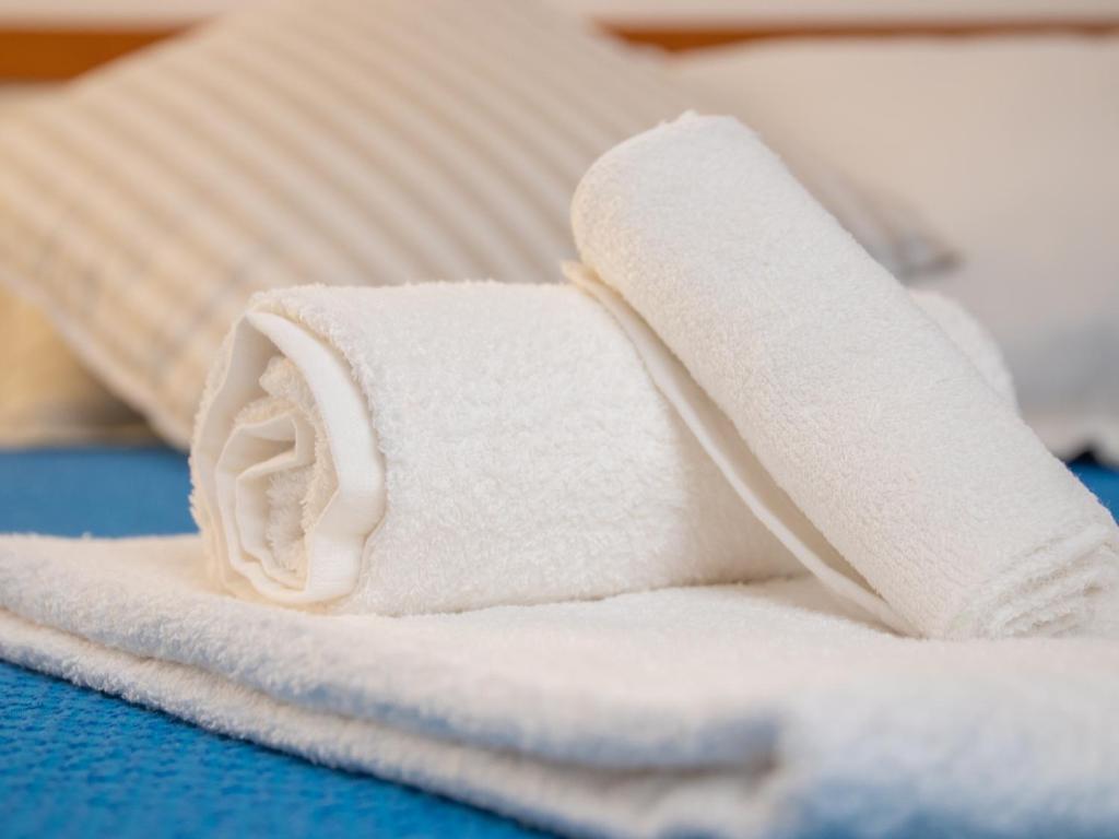 Postel nebo postele na pokoji v ubytování Hotel Merano