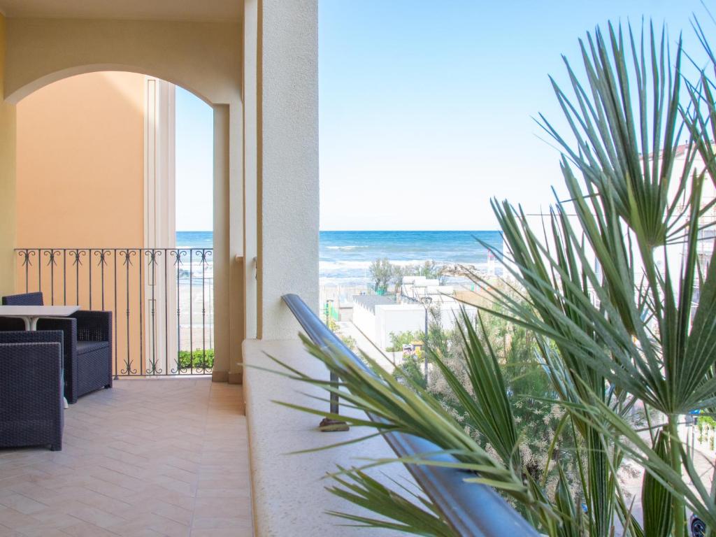 a room with a view of the ocean from a balcony at Hotel Merano in Misano Adriatico