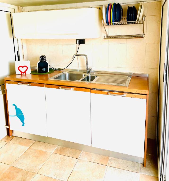 a kitchen with a sink and a counter top at Relax House in Bari