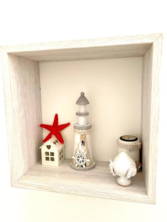 a shelf with a lighthouse and other items on it at Relax House in Bari