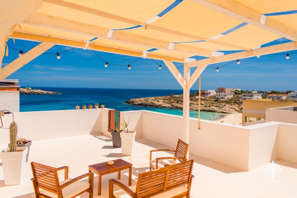 a patio with chairs and a view of the ocean at Almanzar - Residenze sul mare in Lampedusa