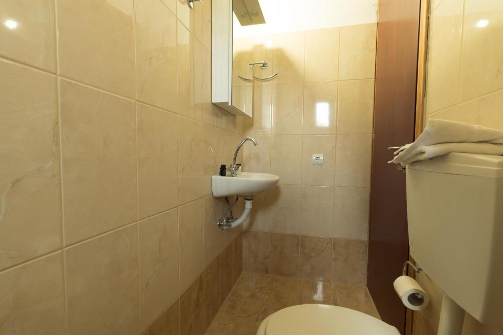 a bathroom with a toilet and a sink at Sunset Home Crete in Paránimfoi