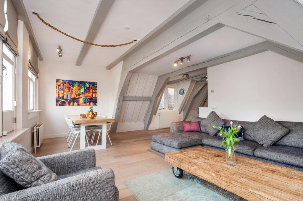 a living room with two couches and a table at Residences Canal Area in Amsterdam