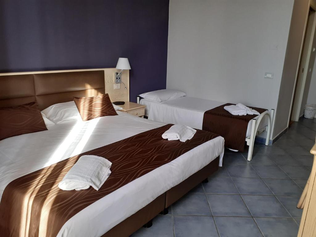 Кровать или кровати в номере Hotel Soleluna