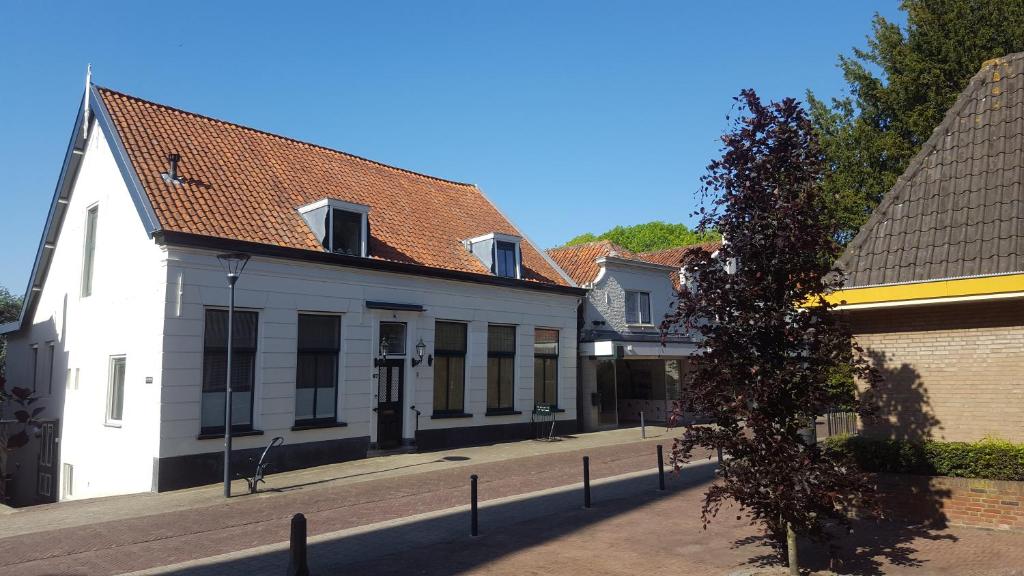 Une rangée de bâtiments blancs dans une rue dans l'établissement BB Salem, à Strijen