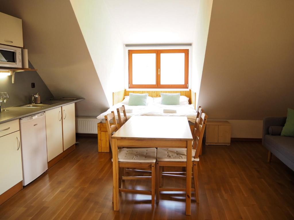 a kitchen and dining room with a table and chairs at Chalupa na dobrém místě in Prostřední Bečva