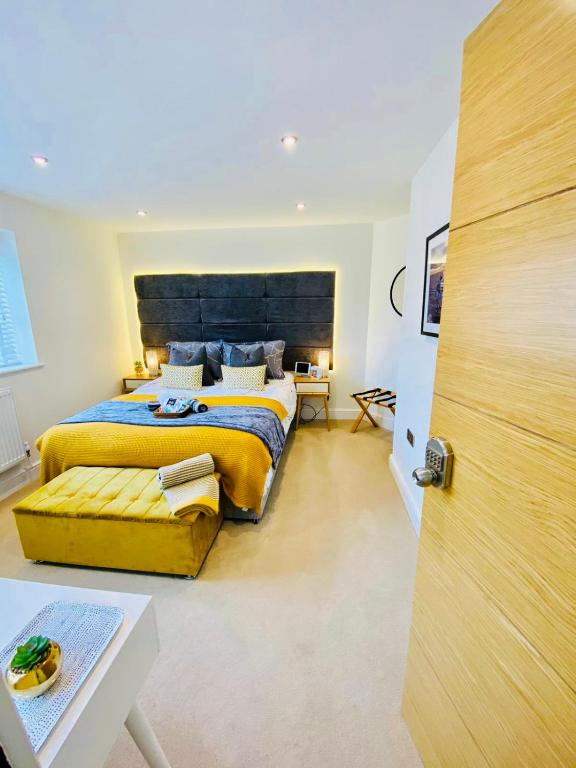 a bedroom with a large bed with a large wooden headboard at The Duplex Margate with Deck & Living Space Air Conditioning in Margate