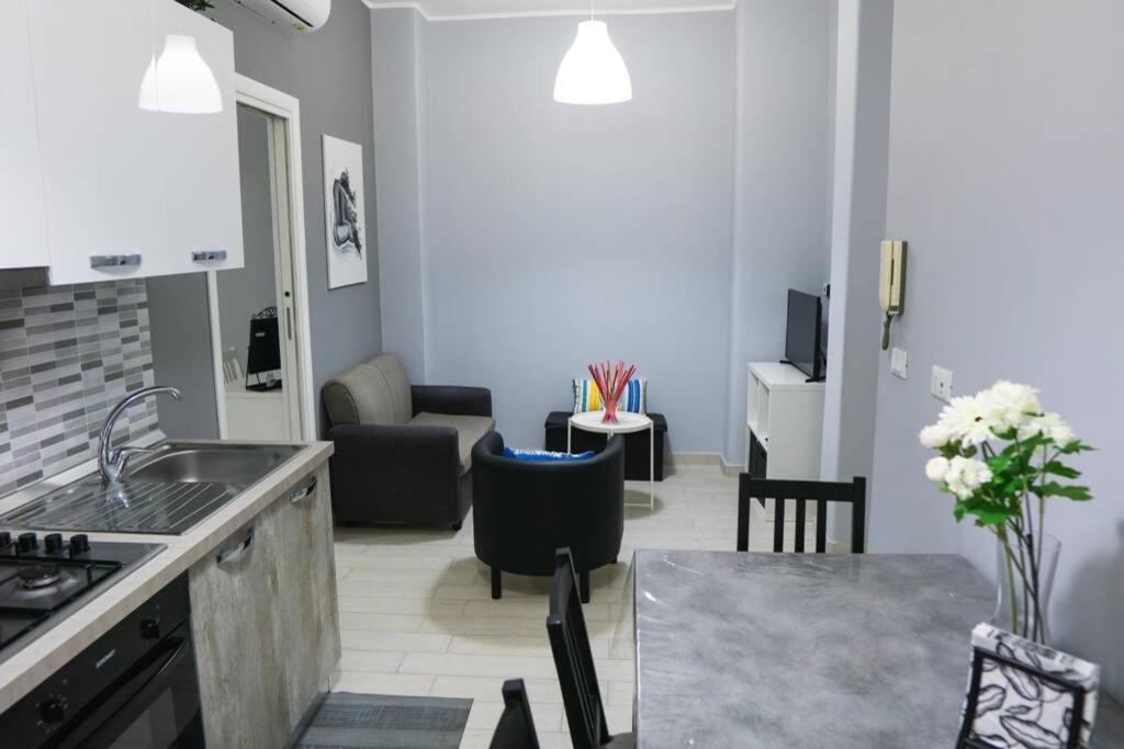 a kitchen and living room with a sink and a table at Casa Mitch in Catania