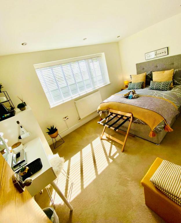 a bedroom with a large bed and a window at The Duplex Margate with Deck & Living Space Air Conditioning in Margate