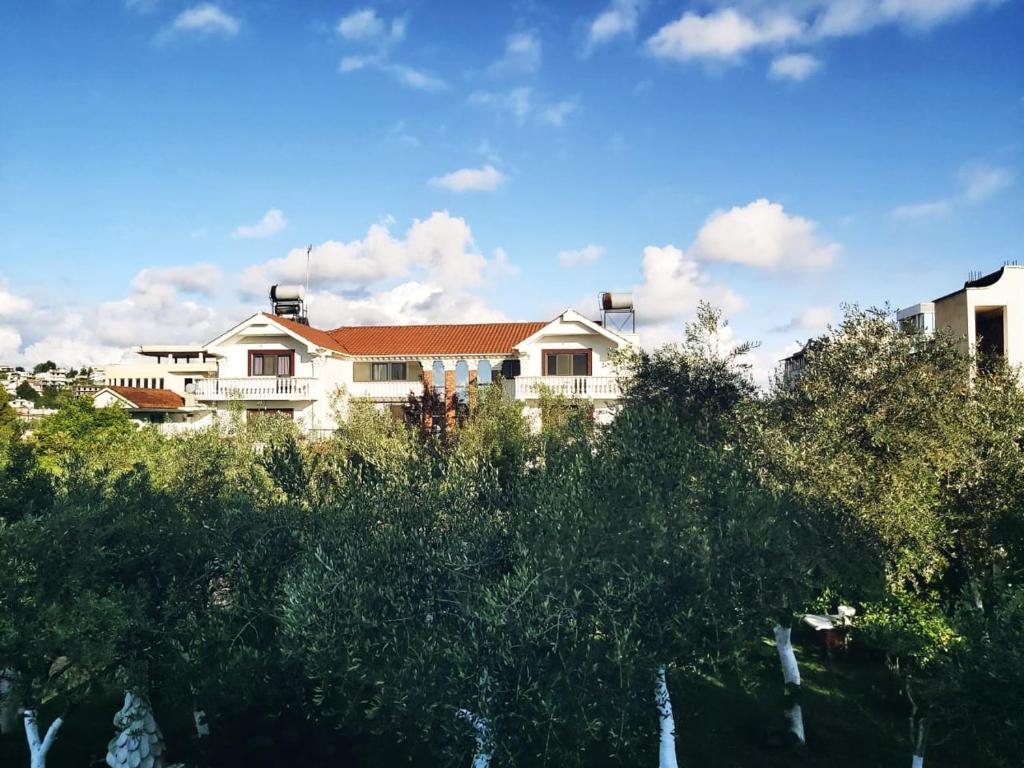 a large white house with trees in front of it at Villa Kasa in Durrës