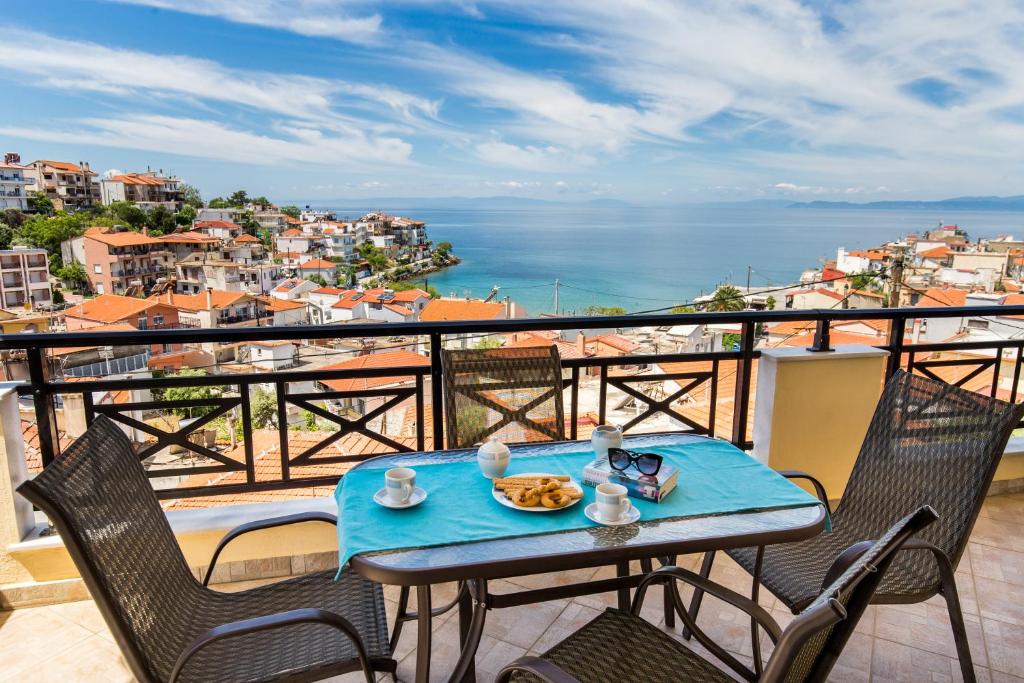 a table with a plate of food on top of a balcony at Villa Smaro in Skala Marion