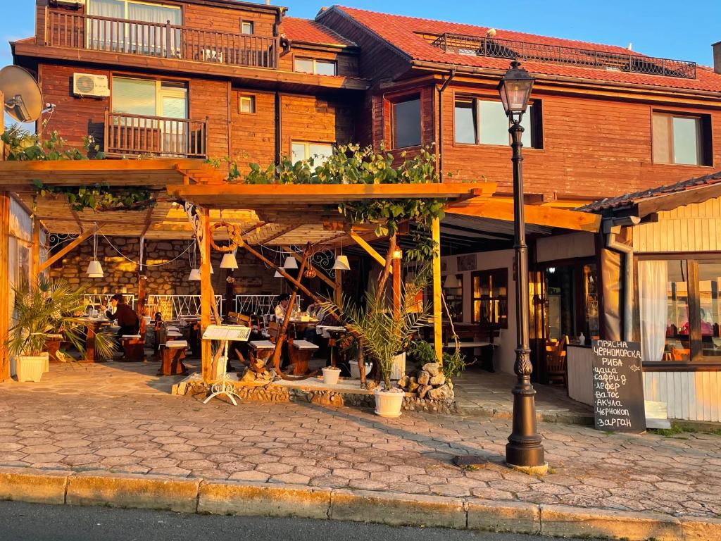 a building with a street light in front of it at The Two Anchors in Nesebar