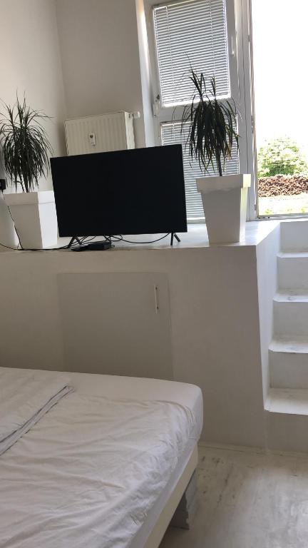 a bedroom with a desk with a computer monitor on it at INDUSTRIAL STUDIO 1 in Ljubljana