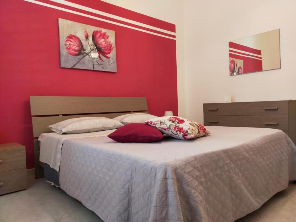 En eller flere senge i et værelse på Casa Vacanze Leonardo