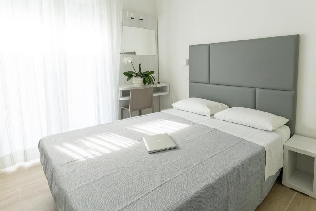 Postel nebo postele na pokoji v ubytování Hotel Eugenio