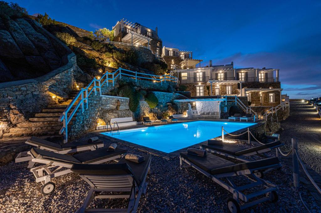 a resort with a swimming pool and a building at Villa Thelgo Mykonos in Psarou