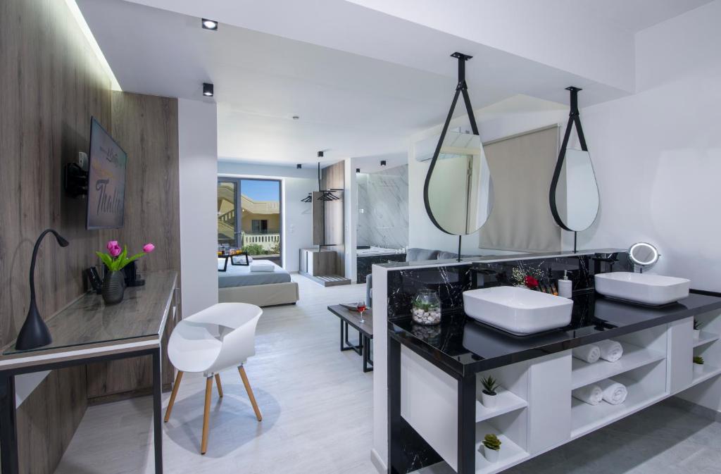 a bathroom with two sinks and a large mirror at xSuites in Agia Marina Nea Kydonias