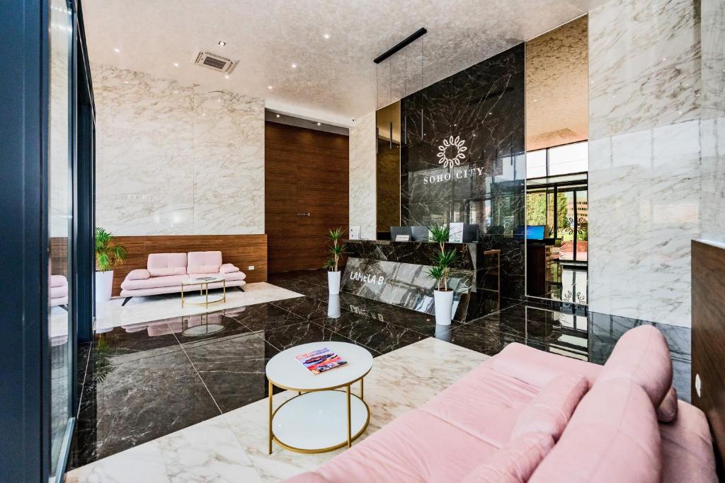 a living room with a couch and a table at Soho Magic Lux in Bar