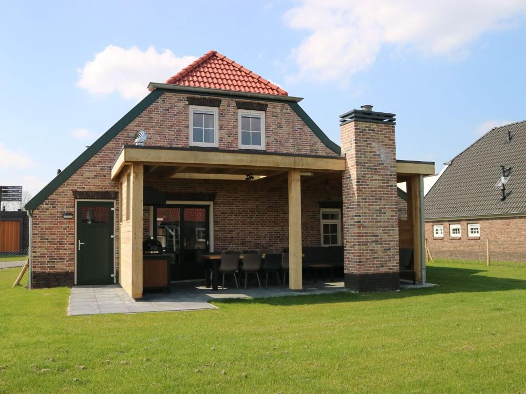 an extension of a house with a patio at Beautiful holiday home with luxury BBQ, in Limburg in Roggel