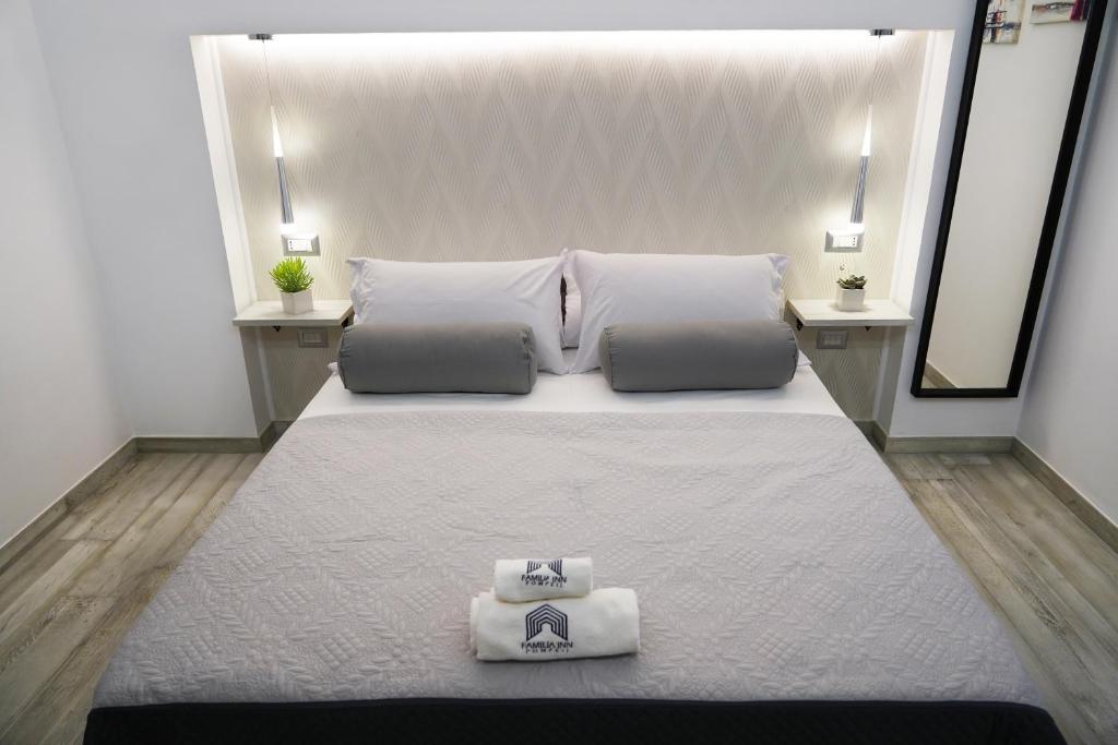 Postel nebo postele na pokoji v ubytování FamiliaINN Rooms & Apartments