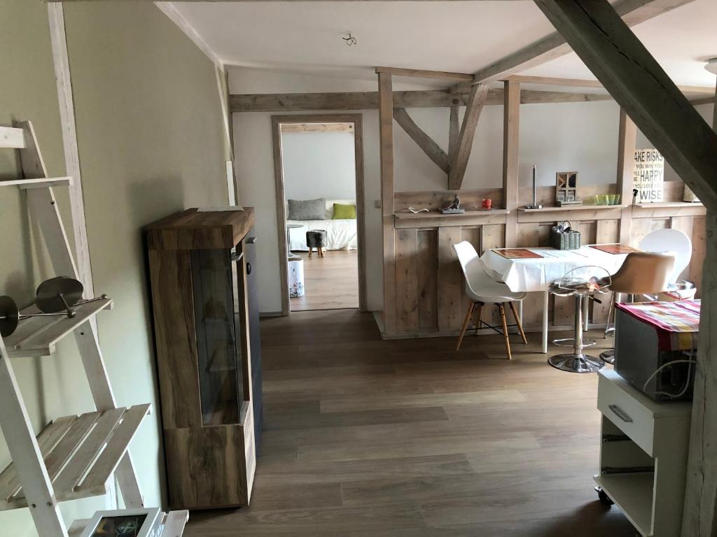 a living room with a table and a dining room at Wohnung Maggy in Bad Liebenwerda