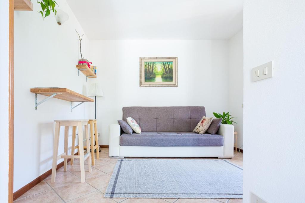 a living room with a couch and a table at La Cà Dol Sùl in Orezzo