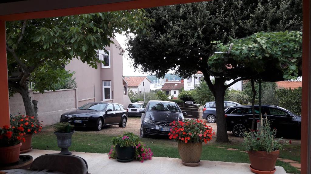 a group of cars parked in a parking lot at Apartments Duda in Pula