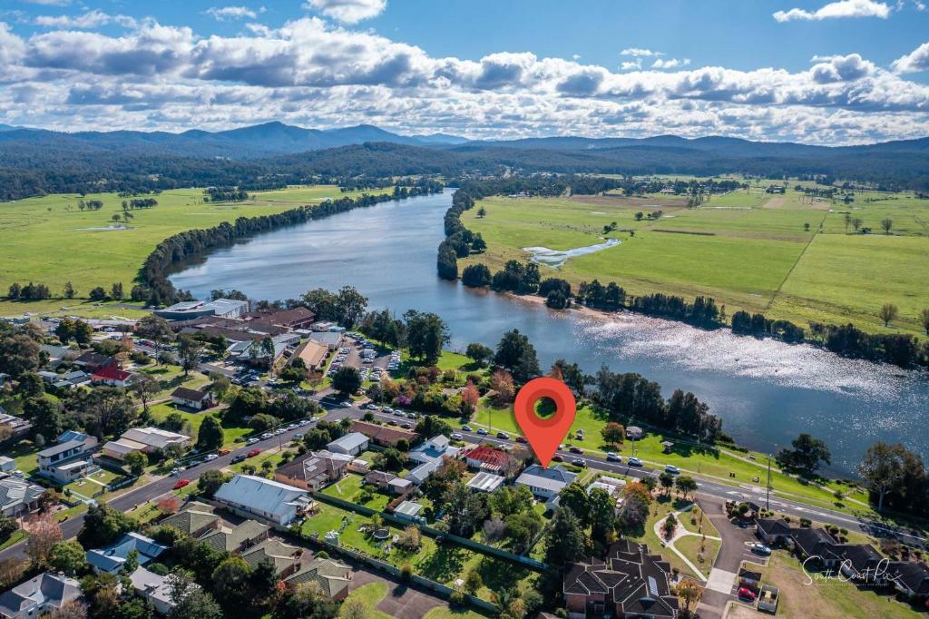 an aerial view of a town next to a river with a red marker at Moruya Holiday House in Moruya