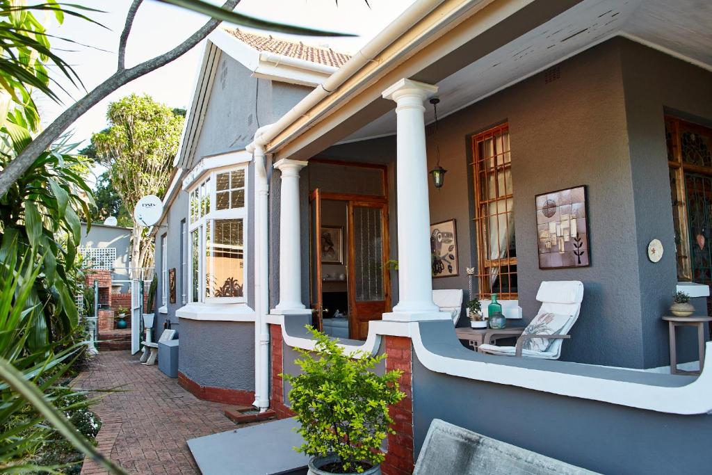 a house with a porch with a chair on it at Tamarisk Bed & Breakfast in Durban