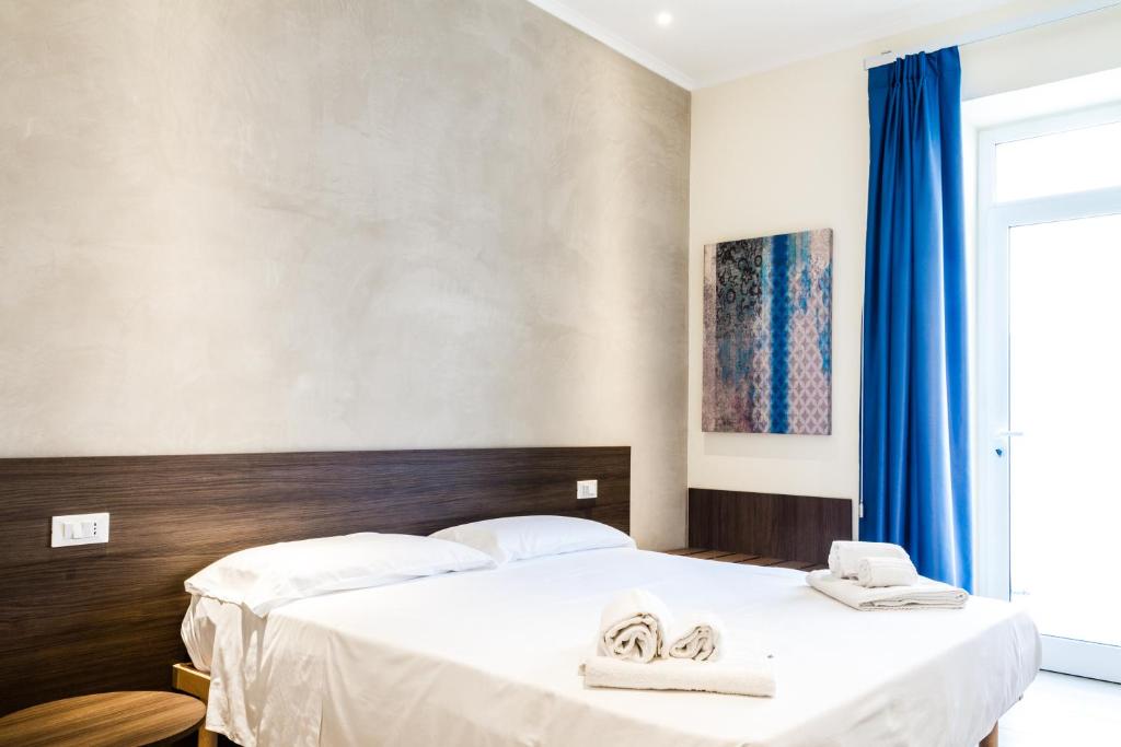 a bedroom with two beds with towels on them at Le Bifore in Gaeta