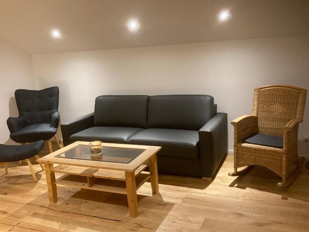 a living room with a couch and two chairs at Ferienwohnung Allgäuflair in Missen-Wilhams