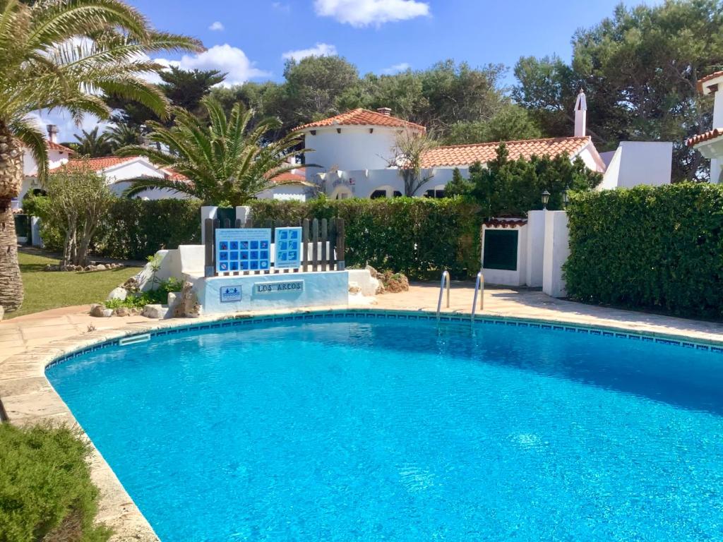 a swimming pool in front of a villa at FONOLL MARÍ in Cala en Forcat