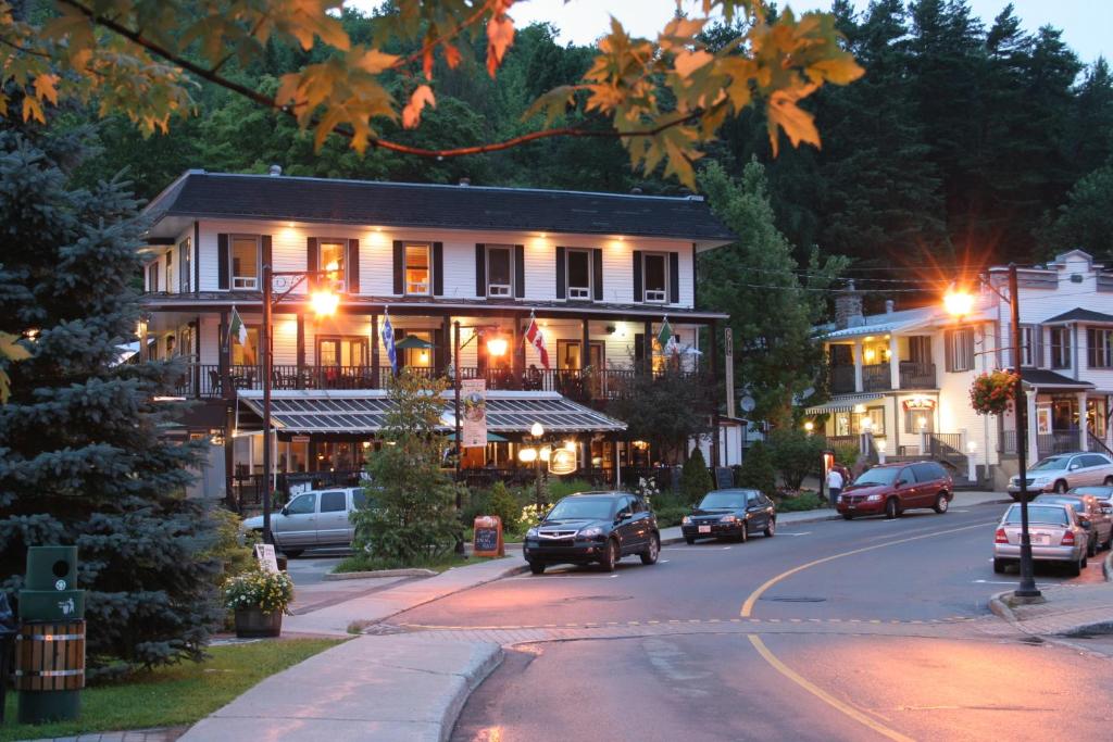 a street with cars parked in front of a building at Hotel Mont-Tremblant in Mont-Tremblant