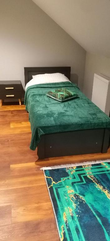 Łóżko lub łóżka w pokoju w obiekcie Apartamenty Green&Blue w Węgorzewie- GREEN