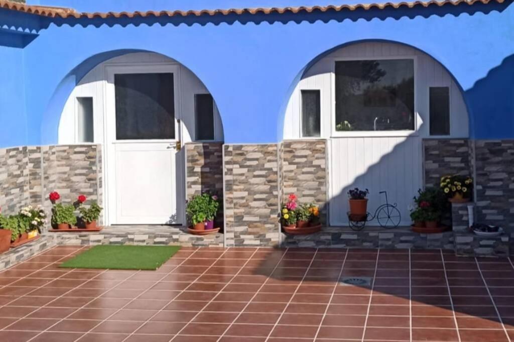 a house with two white doors and potted plants at Finca Villa Clara Cabo de Gata Nijar Almeria in El Viso