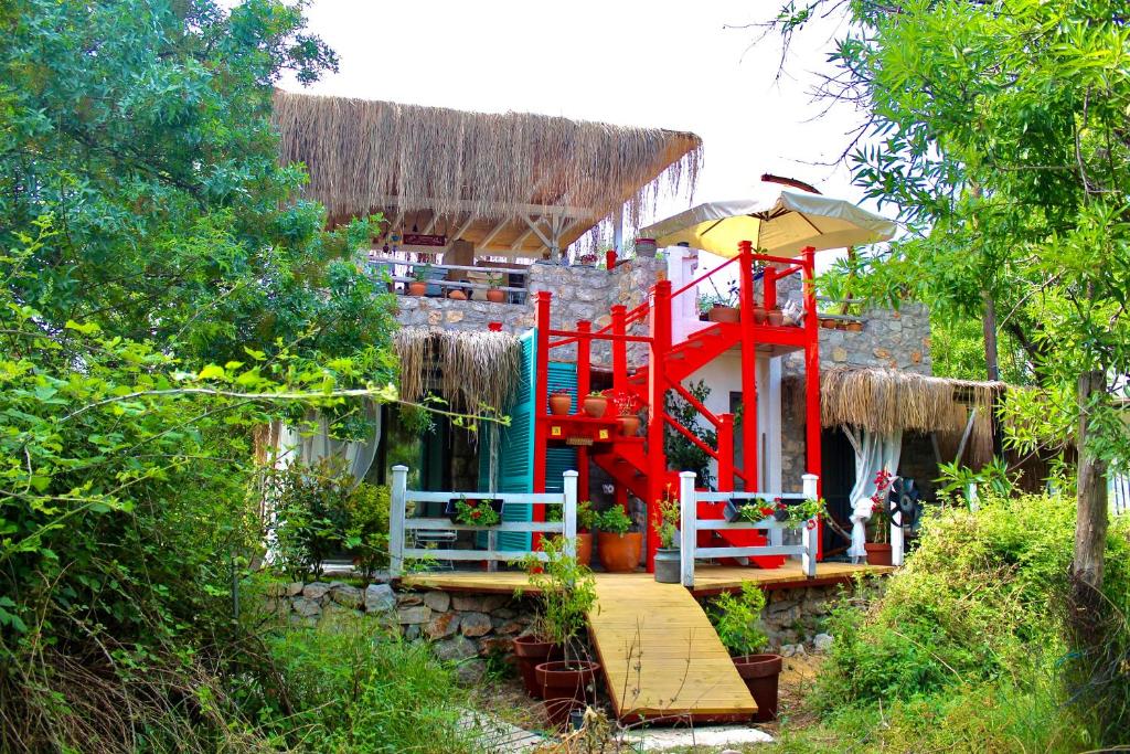 a building with a playground with a red structure at Valentina Boutique Hotel in Bozburun