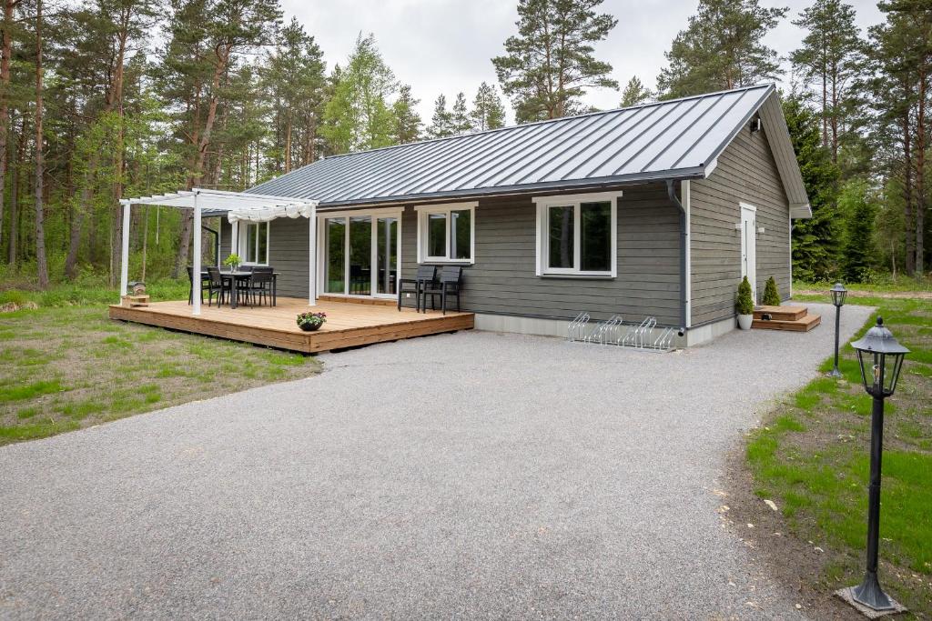 a tiny house with a porch and a patio at Jõeranna Lodge in Paope