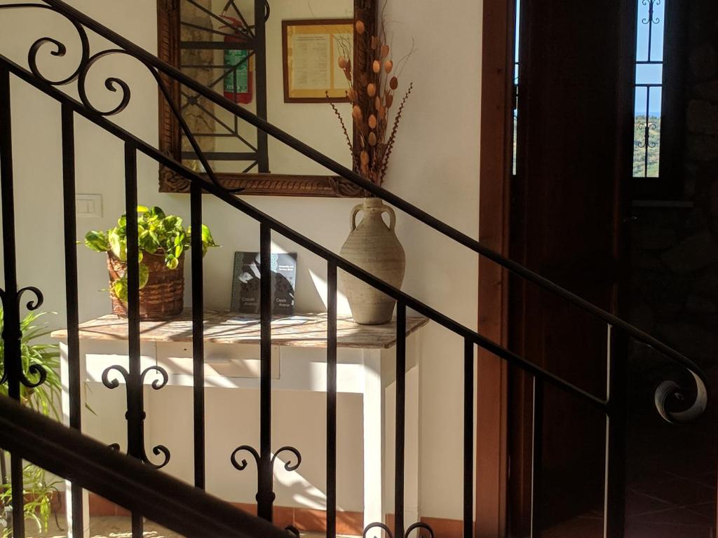 a stairway with a table with a vase on it at Casale Ginisara in Castellammare del Golfo